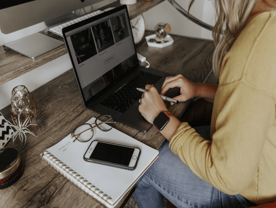 A person casually working on a laptop at home checking vehicle details online, researching eligibility for claiming the federal EV tax credit in 2026