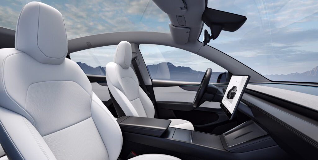 Minimalist white interior of Tesla Model 3 with large central screen and clean dashboard, natural light view for Tesla Model 3 vs Hyundai IONIQ 6 comparison