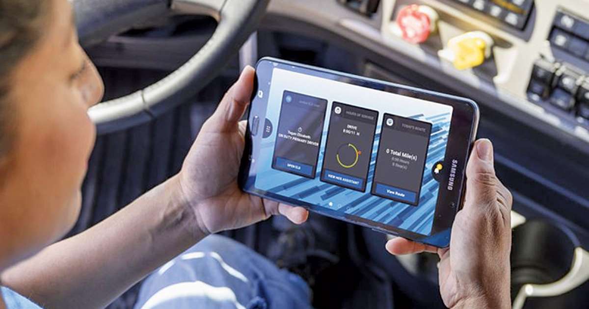 Driver inside vehicle holding tablet showing telematics data, real scene illustrating how safe driving tracking can help lower EV insurance premiums