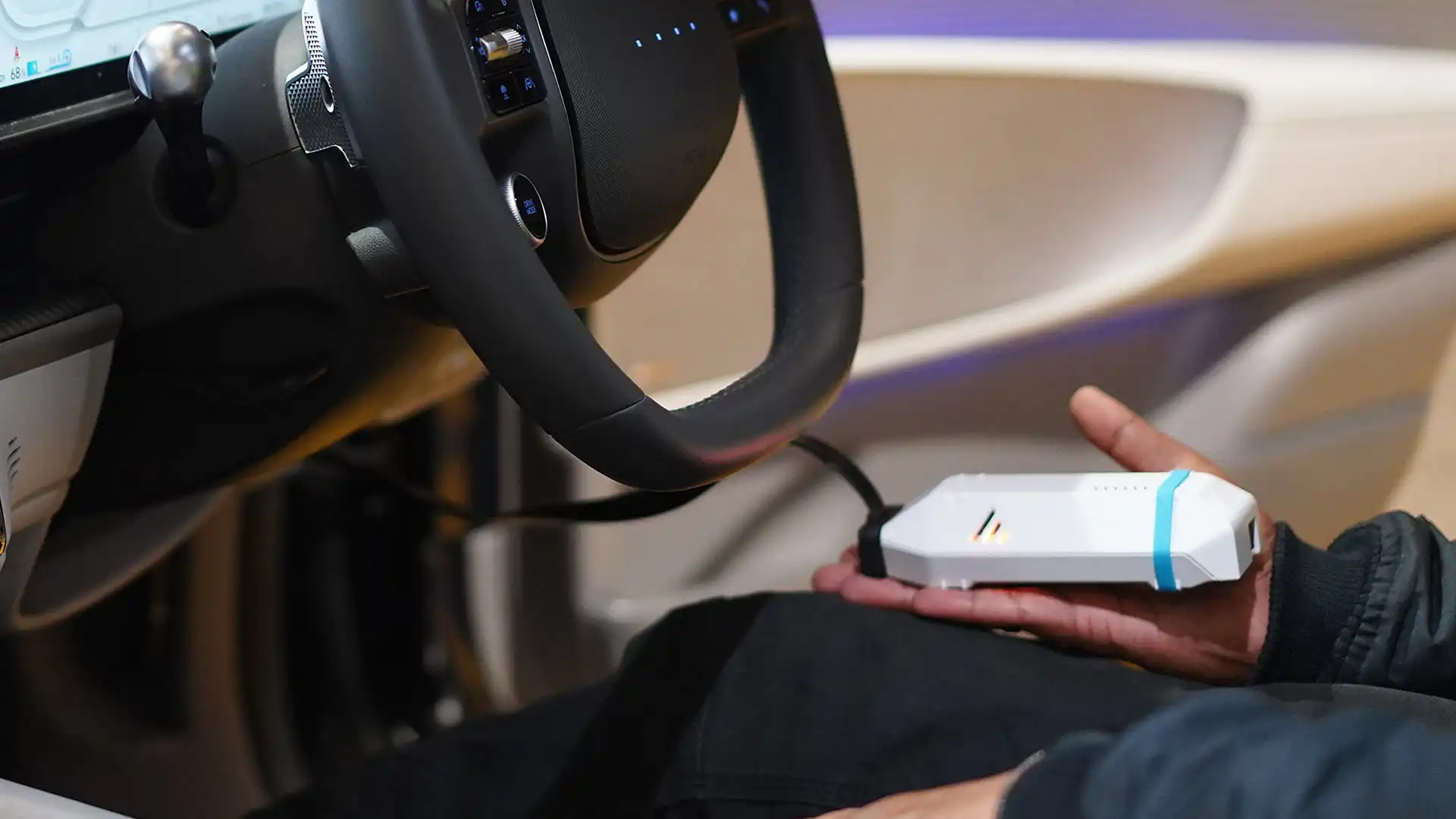 A person using a diagnostic tool inside an electric car to check battery health, an essential step when shopping for reliable used EVs in 2026